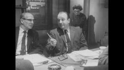 1960s: Man sits at table, talks, points pencil Stock Footage