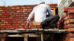 Bricklayer installing bricks on construction site Stock Footage