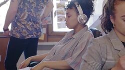 Creative businesswoman with headphones listening to music, relaxing in office Stock Footage
