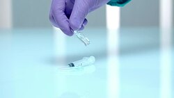 Pharmacist hand holding injection bottle. Hand in gloves shaking medicine vial Stock Footage