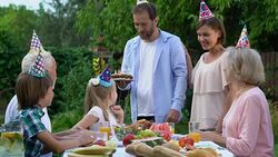 Caring parents bringing cake with candles, celebrating birthday of daughter Stock Footage