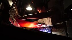 Craftsman working on huge old wooden brocade weaving looms Stock Footage