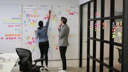 Coworkers in a late meeting working on schedule Stock Footage