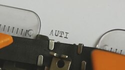 Close up footage of a person writing AUTISM on an old typewriter, with sound Stock Footage