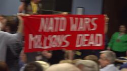 Anti-NATO protesters interrupt address of Micheal Martin News Clip