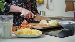 Young woman cutting onion Stock Footage