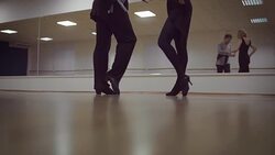 Dancing male and female legs in the dance studio Stock Footage