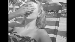 Women lounging beside pool put on eye shields and sunglasses News Clip