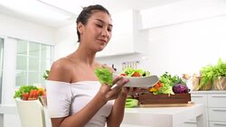 Beautiful Young woman eating salad Stock Footage