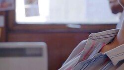 Serene creative businesswoman listening to music with headphones in office Stock Footage