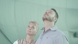 German couple explores inside of partially inflated air balloon Stock Footage