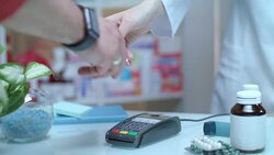 Man buy blister pills. Credit card machine at drugstore Stock Footage