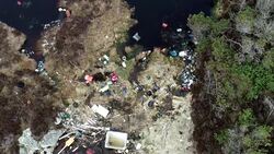 Drone - People clearing out plastic litter News Clip