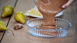 Female chef hands pouring batter into baking dish. Making chocolate pie with pears. Stock Footage