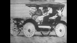 Horseless Carriage Drives in Front of House Stock Footage