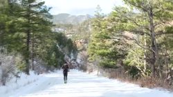 Amir Khan running up a snowy road in Colorado Springs News Clip