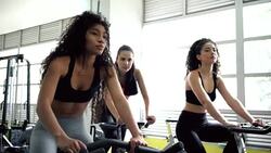 Female friends exercising on the bicycle Stock Footage