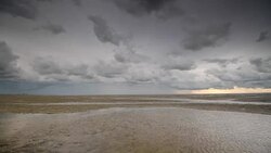 Storm clouds moving in over the Wadden sandflats in the Dutch Waddensea region in the North of The Netherlands. Stock Footage