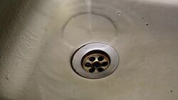 Close up of kitchen sink drain with water drop - Stock video... Stock Footage