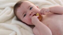 Little baby boy is playing with soother. Stock Footage