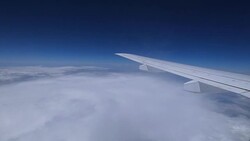 Airplane wing moving above white clouds Stock Footage