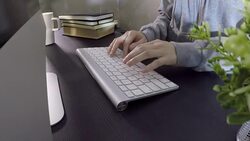 Woman typing on computer in office Stock Footage