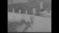 A GI helps malnourished Korean boy and little Korean girl receives food from GI in Korea News Clip