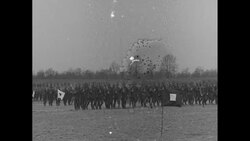 Marching soldiers; officer pinning medal; 1920s News Clip