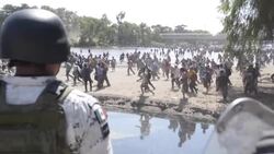 CLEAN : Troops clash with migrants as they try to storm into Mexico News Clip