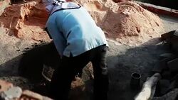 Worker mixing cement on construction site. Stock Footage