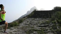 Running woman trail runner on the great wall top of mountain Stock Footage