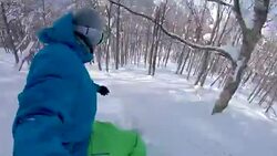 SELFIE: Male rider carving between trees on freshly fallen snow on his snowboard Stock Footage