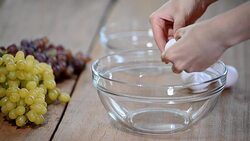 Woman hands breaking an egg to separate egg white and yolks and egg shells at the background. Stock Footage