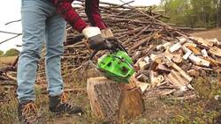 Lumberjack fixing / maintain the chainsaw outdoors. Stock Footage