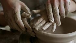 Hands of Pottery Teacher Helping Kid Throwing Bowl Stock Footage