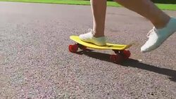 teenage girl feet riding short modern skateboard Stock Footage