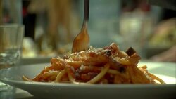 CLOSE ANGLE OF PERSON TWIRLING SPAGHETTI OR PASTA ON FORK. TOMATO SAUCE. PARMESAN CHEESE. ITALIAN FOOD. Stock Footage