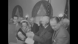 Pres. Dwight Eisenhower receives an inscribed crystal bowl from his cabinet as a first year anniversary gift News Clip