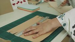 Woman artist is cutting paper Stock Footage
