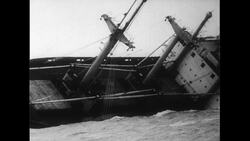 Atlantic Ocean, 1952: The Flying Enterprise turns sideways in waters and starts submerge as it is towed back to port Stock Footage