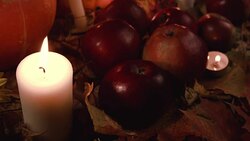 Harvest red apples and dry grass rests on autumn leaves. Stock Footage