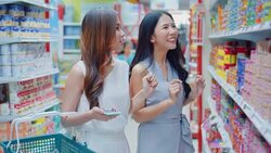 Two young women shopping in supermarket Stock Footage