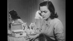 1950s: Wife sits with head in hand at vanity table Stock Footage