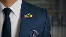 Businessman Walking Towards Camera With Friend Country Flags Pin United States of America - Mali.mov Stock Footage