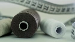 Spools and Measuring Tape Lying on Table Stock Footage