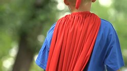 Strong superboy wearing mask and costume showing strength, self-confidence Stock Footage