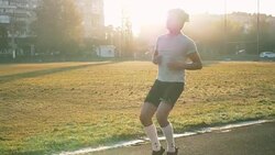 Mixed race athlete runner does high knees, while running in place at stadium Stock Footage