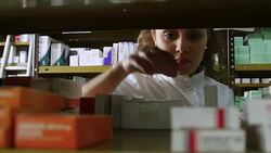Pharmacist examining medicines on rack in pharmacy Stock Footage