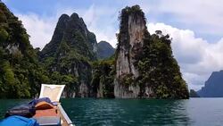 Moving follow boat with Beautiful mountains lake river sky and natural attractions in Ratchaprapha Dam at Khao Sok National Park, Surat Thani Province, Thailand. Stock Footage