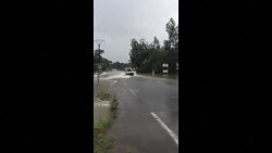 CLEAN : Cyclone Uesi: Cars drive through flooded road in New Caledonia News Clip
